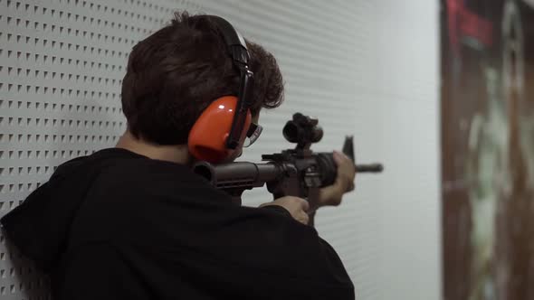 Man Shooting at Firing Range in Protective Headphones