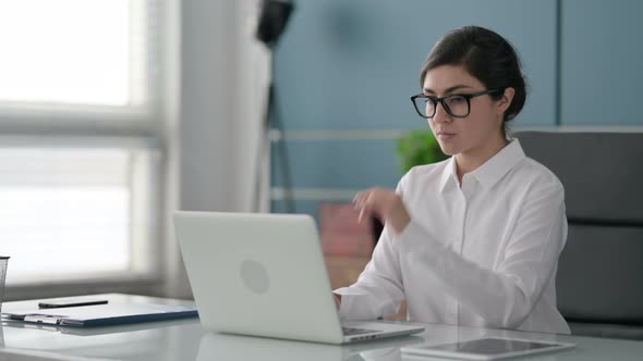 Indian Businesswoman Thinking while Working on Laptop in Office