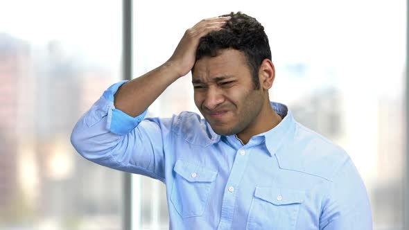 Overworked Young Man Suffering From Headache.