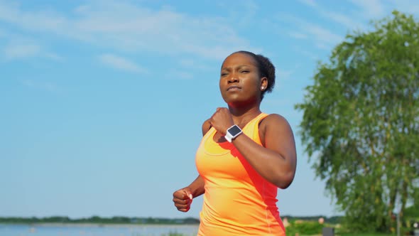 Young African American Woman Running at Seaside