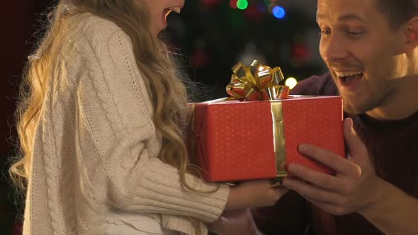 Little Daughter Presenting X-Mas Gift to Father, Cute Girl Hugging Loving Dad