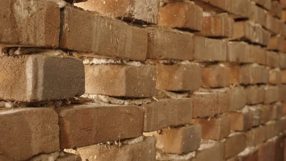 Close-up tilt on weathered house wall texture details  4K 2160p 30fps UltraHD footage - Old bricks  