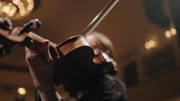 Female Violinist is Playing Music Closeup View of Old Expensive Violin and Female Hands