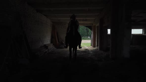 Cowboy in a Hat Rides a Horse Takes a Horse Out of the Stable for a Walk Life in the Countryside