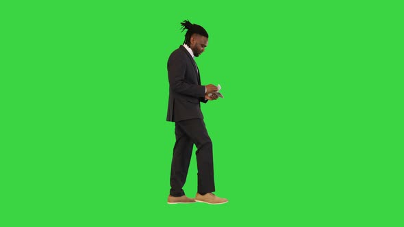 Black Man in Office Suit Walk Counting Money on a Green Screen Chroma Key
