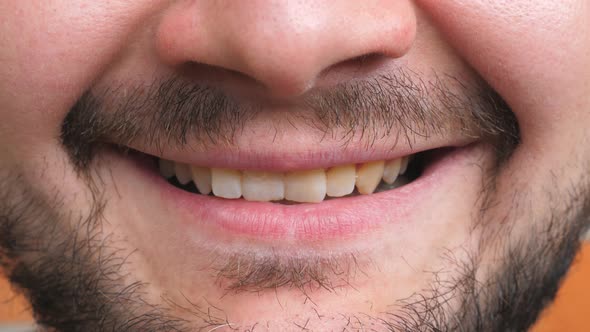 Close Up Mouth of Young Bearded Man Smiling and Showing White Teeth