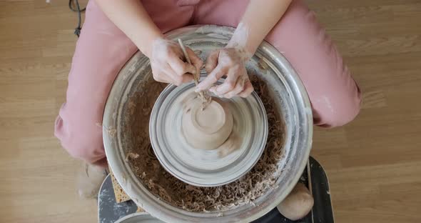 Female Potter Sitting and Makes a Cup on the Pottery Wheel, Woman Making Ceramic Item, Pottery