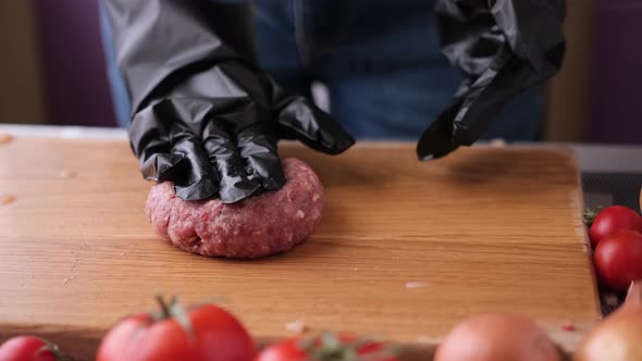 Woman Chef in Black Gloves Prepares Cutlets at Domestic Kitchen on a Wooden Cutting Board