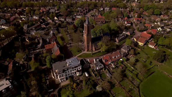 Central church square aerial view of Dutch painterly picturesque town Amerongen surrounded by garden