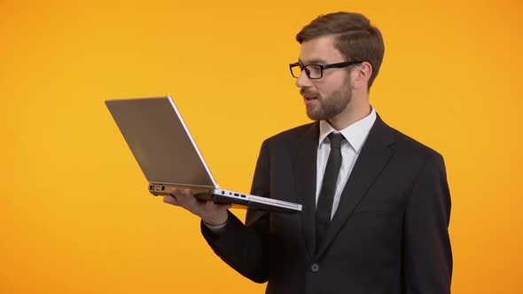 Smiling Man Reading E-Mail and Showing Ok Sign, Winking at Camera, Promotion