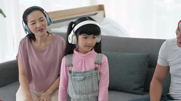 Concept of family stay at home, The daughter was wearing headphones to music and practicing dancing.