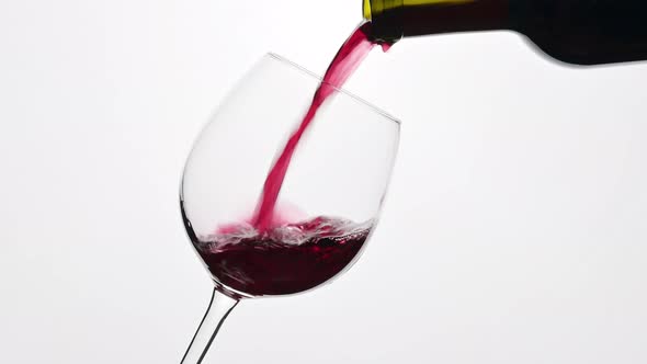 Red Wine Is Pouring Into A Glass