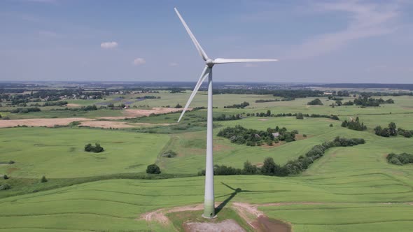 Aerial view of windmills farm for energy production on beautiful cloudy sky at highland. Wind power 