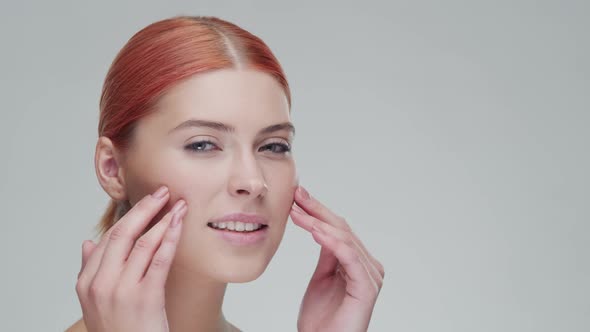 Studio portrait of young, beautiful and natural redhead woman. Beauty concept.