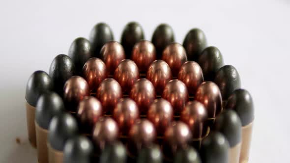 Close up of many ammunition are arranged in a row and rotated with a rotating platform. 4K, 50fps