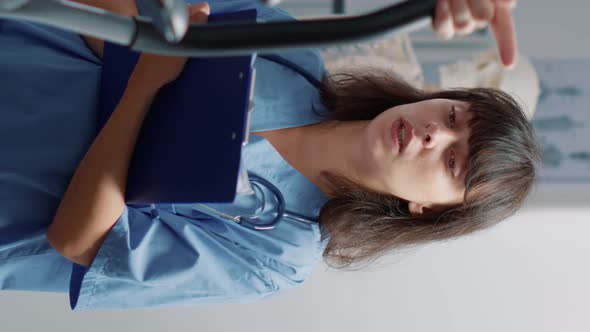 Vertical Video Medical Assistant Supporting Senior Patient Doing Physical Exercise