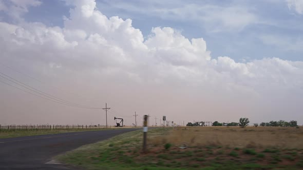 Driving through West Texas looking out the window at dust storm blowing in