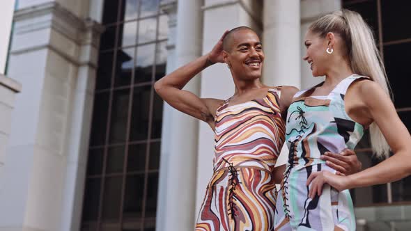 Fashion Models Smiling Together In Brightly Coloured Clothing