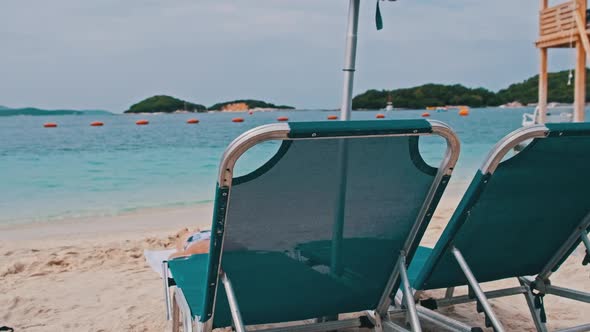 Empty Sun Loungers on the Sandy Beach Against the Turquoise Sea Albania Ksamil