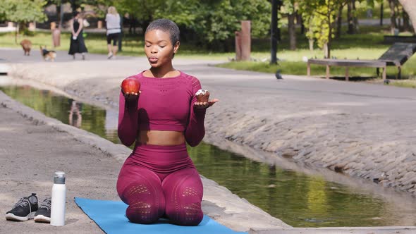 Plus Size Model African American Beautiful Woman Sitting on Yoga Mat After Training in Summer Park