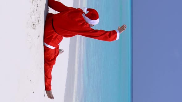 Santa Claus on the Beach with White Sand and Azure Sea Water