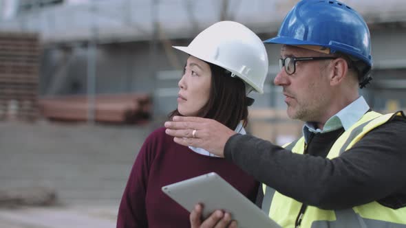 Construction workers looking at project development