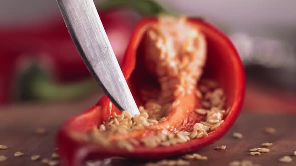 Slow Motion of Grains From Red Chilli Pepper with Knife