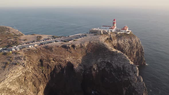 Aerial approaching Lighthouse of Cabo de Sao Vicente, Sages, Algarve. Establishing shot