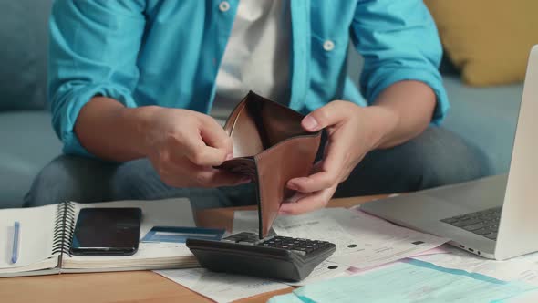 Close Up Of Man's Hand Holding And Opening The Wallet To Check Money