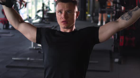 Muscular Man is Engaged in the Gym