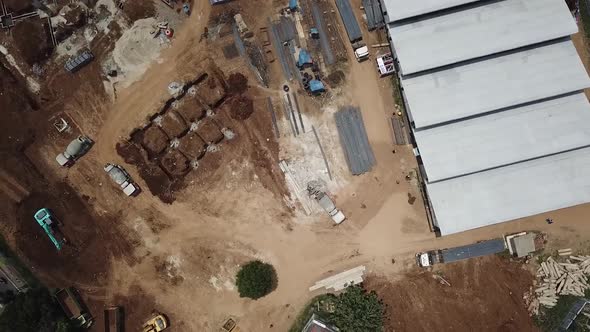 Aerial Work in Progress Construction Site Trucks Overhead Drone Shot