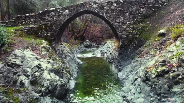 Ancient Bridge Over a Mountain River Abandoned Structure in the Wild Forest River Stones in Autumn