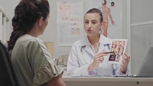 Doctor Telling Ultrasound Results to Pregnant Woman