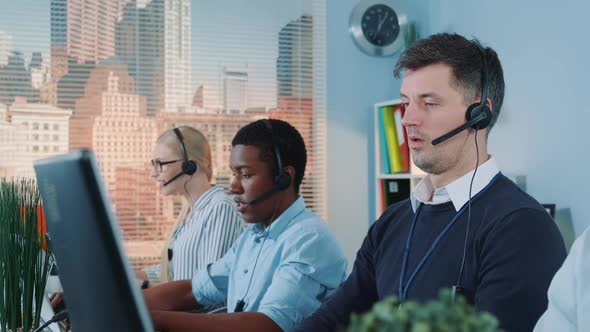 Close-up of Caucasian Call Centre Executive Helping a Client with a Sale By Talking on Phone