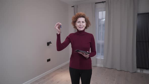Real Estate Senior Saleswoman Holding the Keys to New Apartment