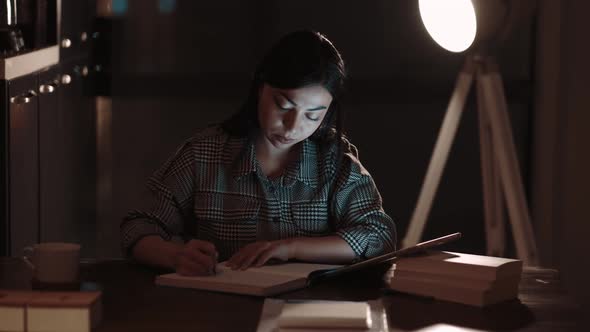 Woman Writing Notes in Tablet