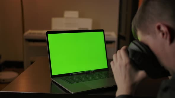 Man Engineer with VR Helmet Programming on Laptop with Green Screen