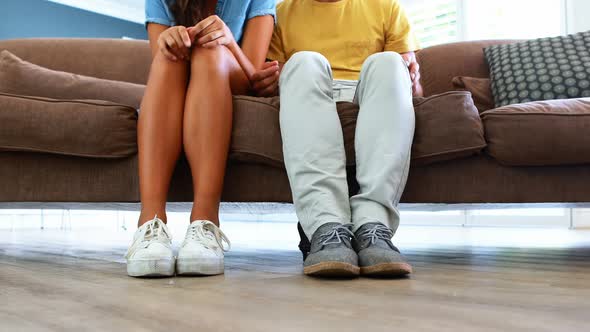 Couple sitting together on sofa in living room