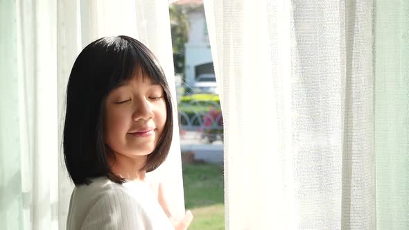 Close Up Of Happy Asian Girl Opening Window Curtains Slow Motion 