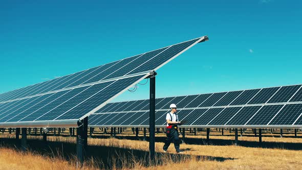 Solar Power, Solar Panel, Solar Farm Concept, Maintenance Man Is Inspecting a Solar Power Field