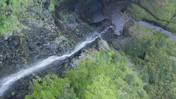 Aerial is flying above Waterfall Risco slowly forward