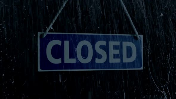 Rain Hits Store Window With Closed Sign