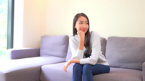 Asian woman sit on sofa and relax