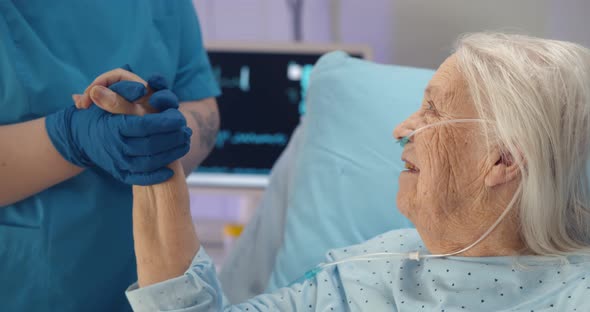 Medical Doctor Holing Senior Patient Hand and Comforting Her