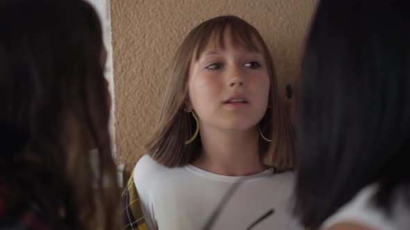 Closeup Portrait of Scared Caucasian Teenage Schoolgirl Talking Asking Bullies Let Go As Angry Girls