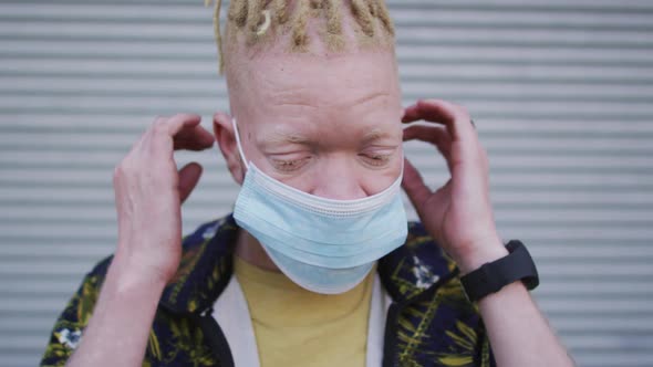 Albino african american man with dreadlocks wearing face mask