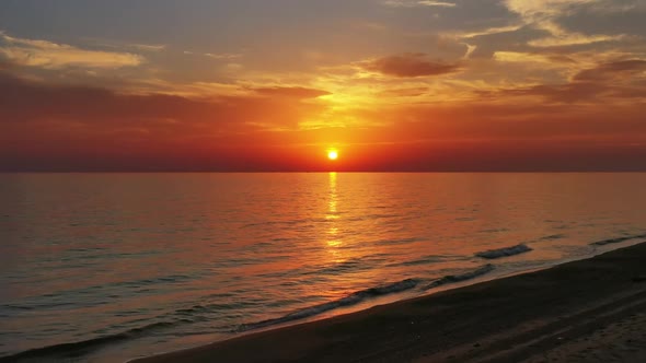 Beach and Calm Sea Surface During Sunset