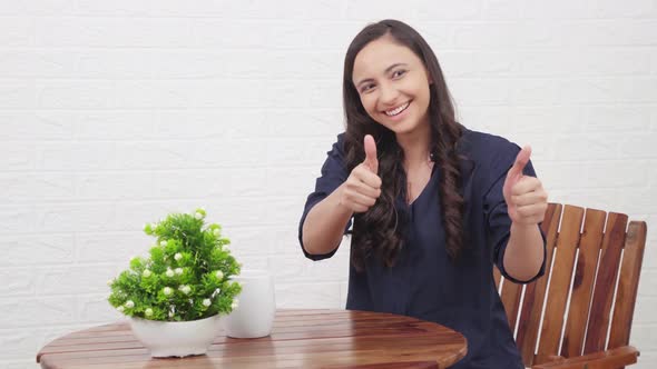 Indian girl showing thumbs up