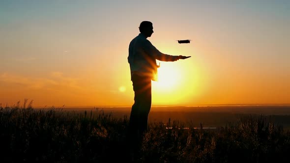 Man with Drone at Sunrise