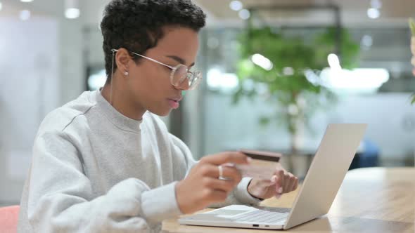 Online Payment Success on Laptop By Casual African Woman 